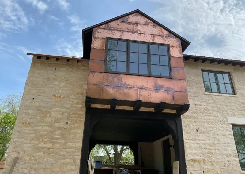 Copper metal panel facade on a stone building for Roof Repair in Bel Aire